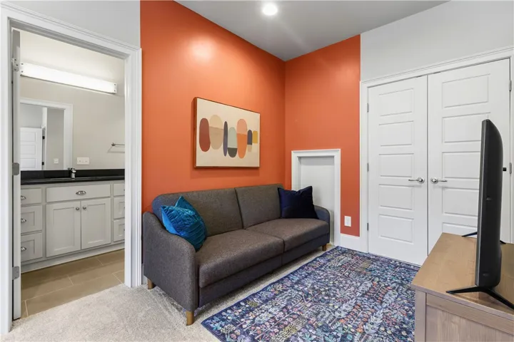 Plush carpeting meets crisp trim in a versatile flex space adjacent to a modern bath.