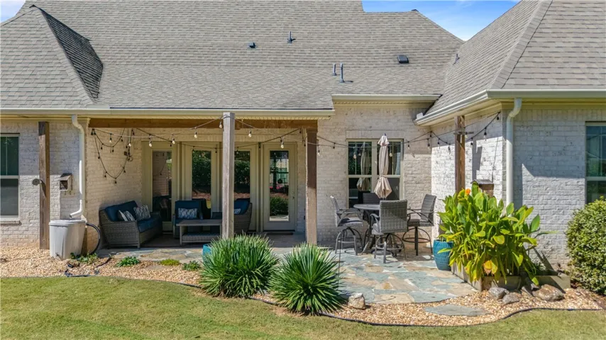 An inviting flagstone patio offers a spacious covered seating area for entertaining.