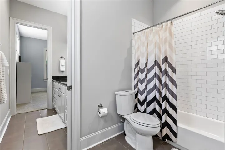 Crisp subway tile accents the shower tub combination in this well-appointed bathroom.
