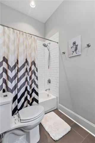 Classic subway tiling surrounds the shower and tub in this clean bathroom setting.
