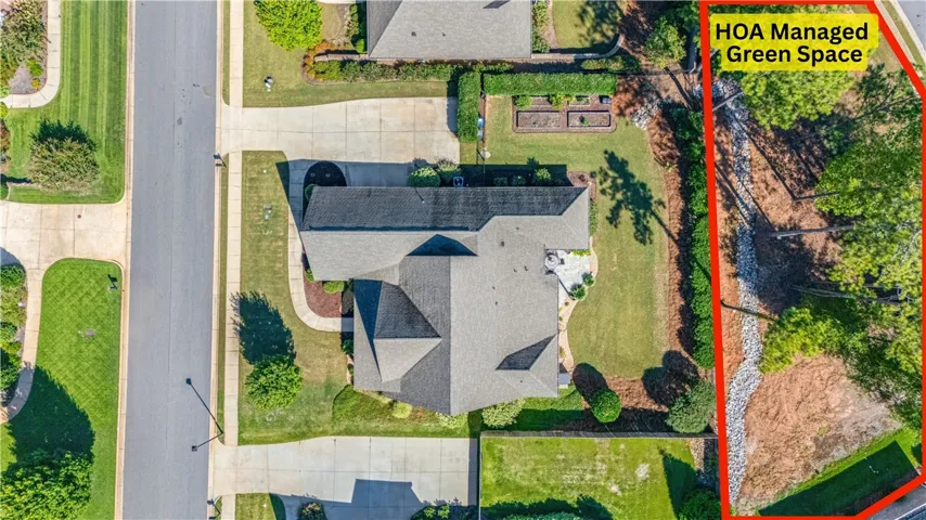 An aerial perspective showcases the shingle roof architecture and adjacent community green space.