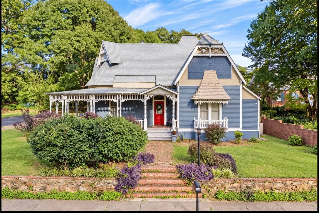 Ornate Victorian architectural details and a wrap-around porch define this classic exterior.