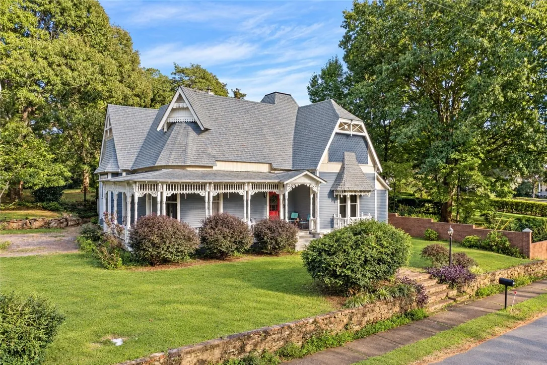 A wrap-around porch and classic gables highlight this classic two-story Victorian home.