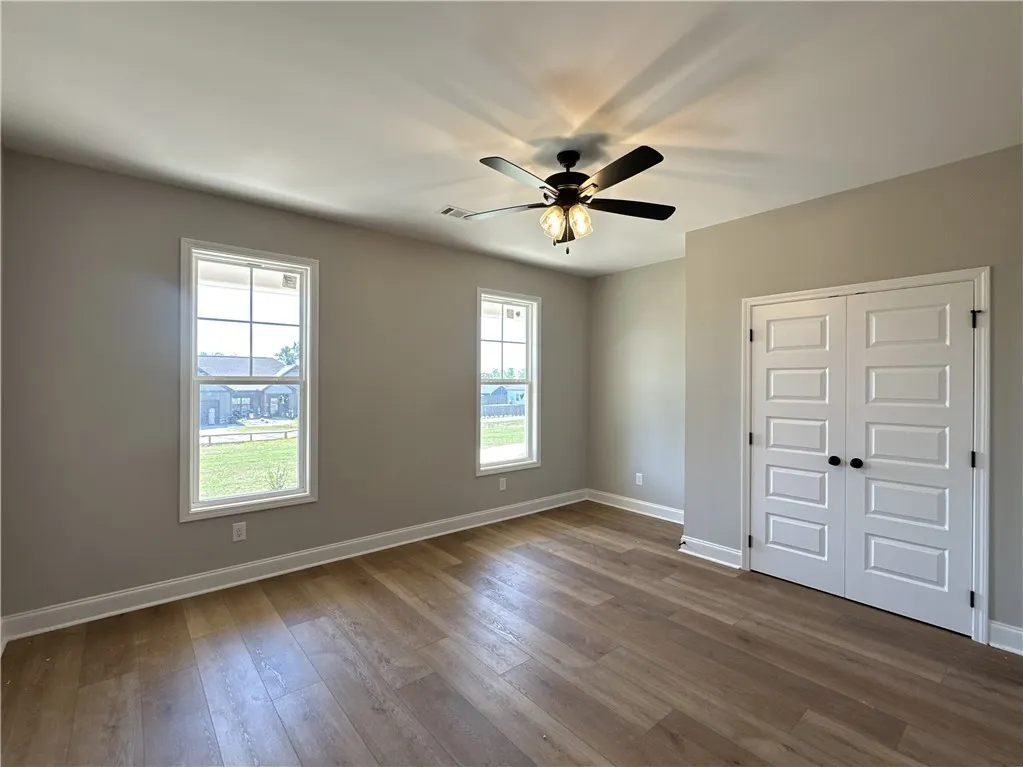 Gleaming hardwood floors and classic double doors anchor this versatile, light-filled space.