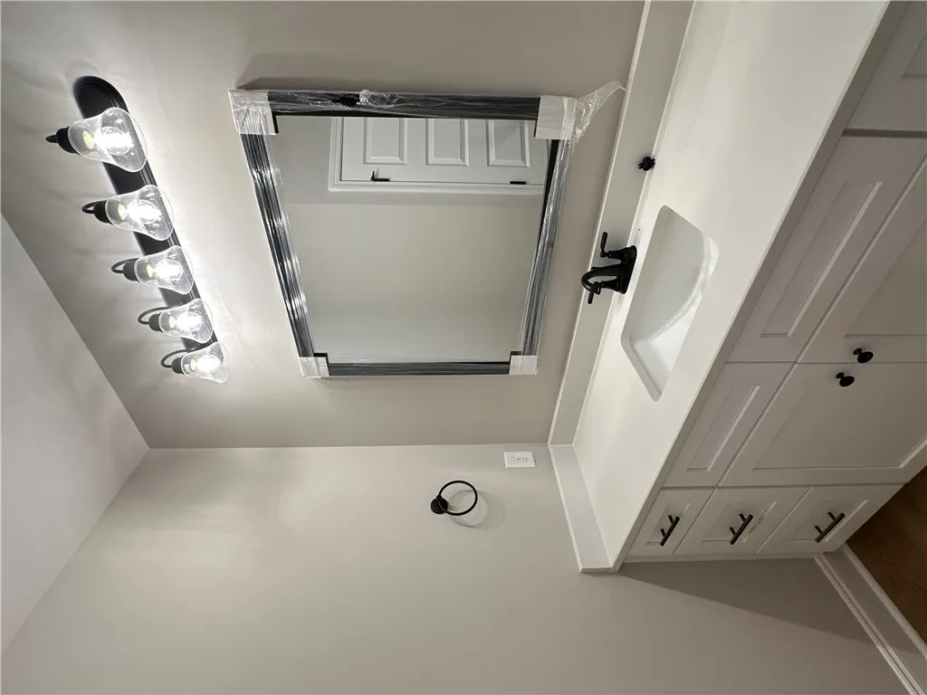 Modern vanity cabinetry pairs with clean design lines in this fresh bathroom space.