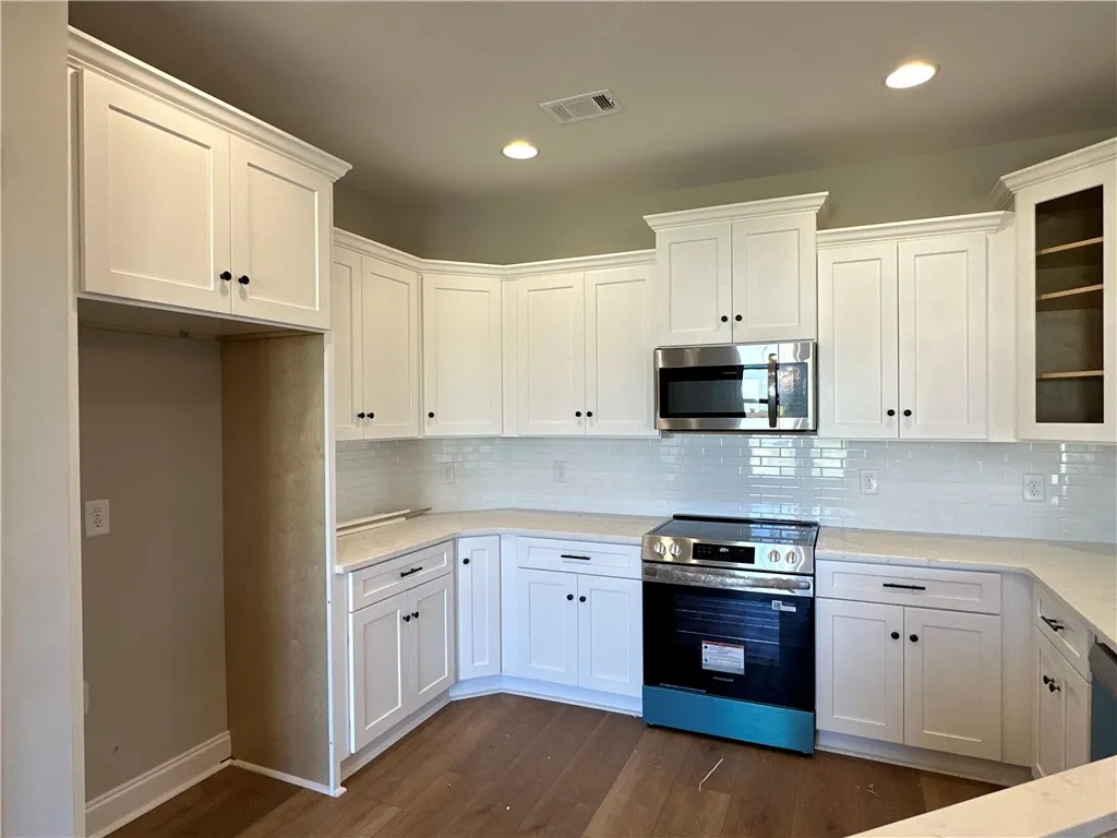 Gleaming stone countertops and shaker cabinetry define this modern culinary space.