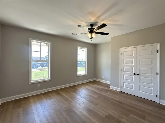 Gleaming hardwood floors and classic double doors anchor this versatile, light-filled space.