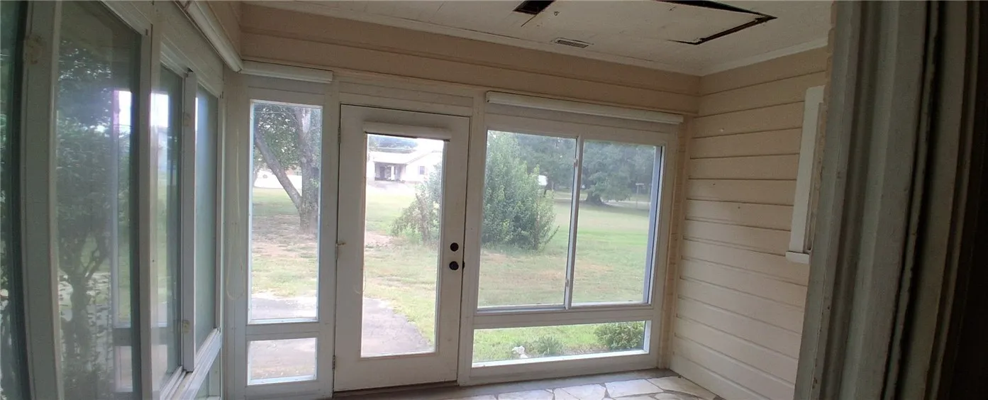 An enclosed porch /Sunroom generous windows overlooking the yard.