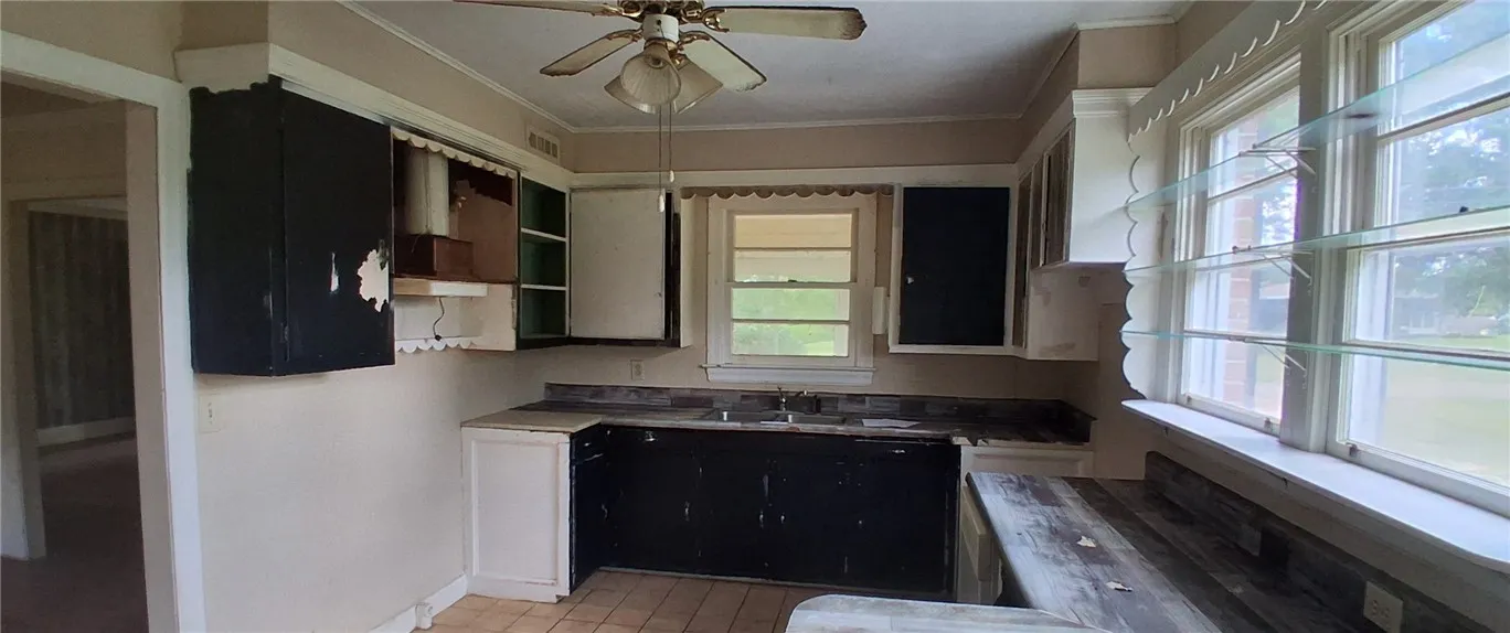 abinetry await updates in this traditional kitchen layout.