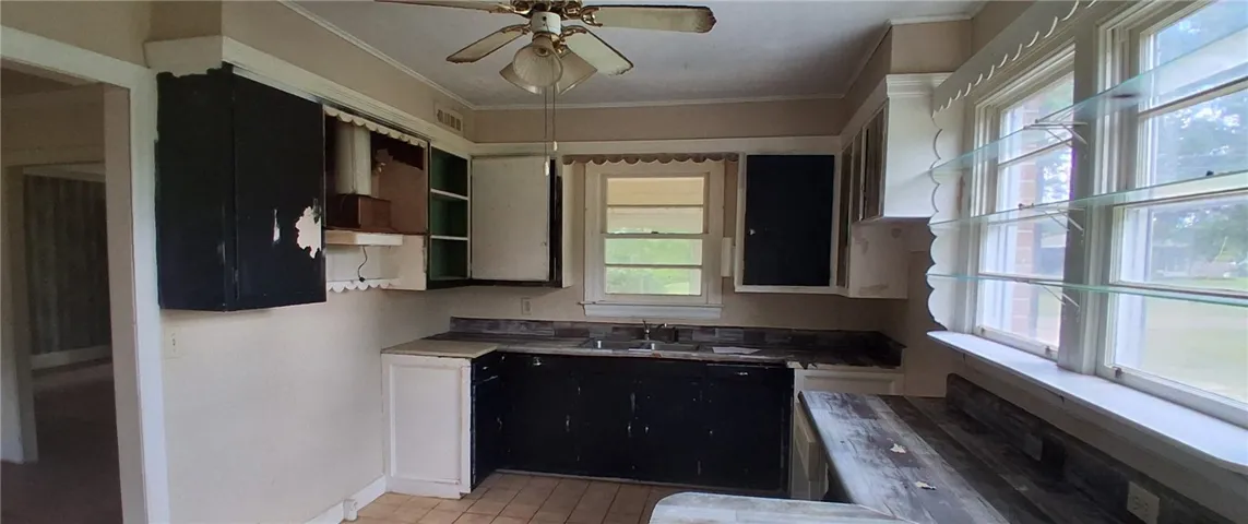 abinetry await updates in this traditional kitchen layout.