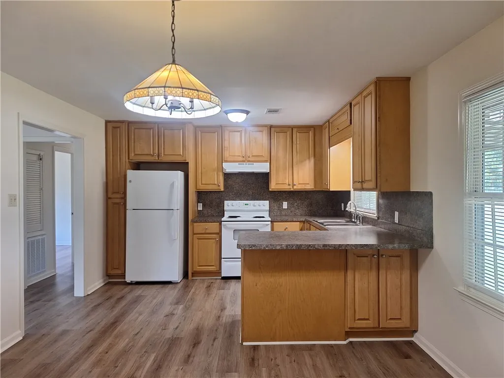 Ample wooden cabinetry and durable flooring define this highly functional kitchen space.