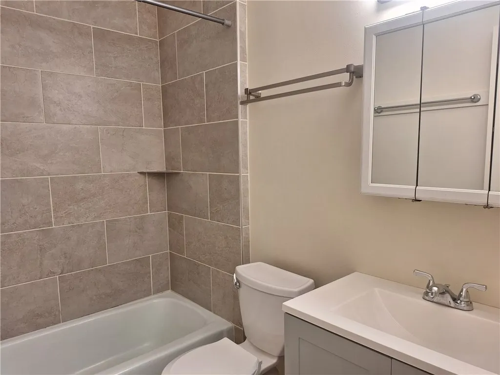 A classic tiled shower surround pairs with a modern vanity in this bathroom.