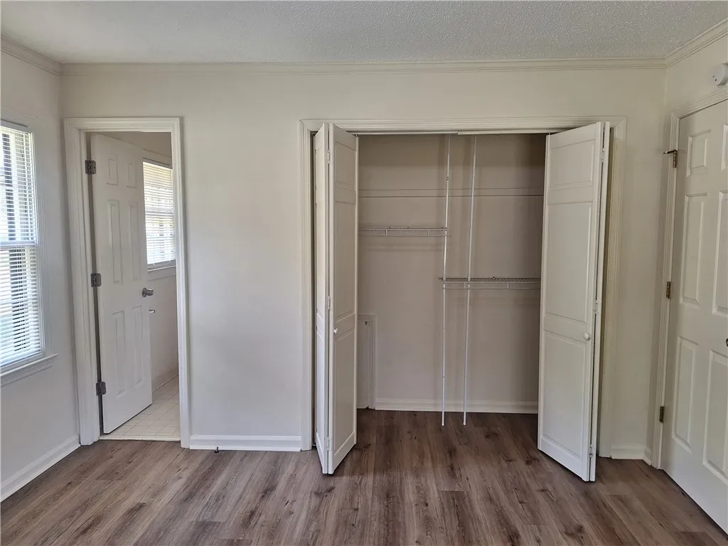 A spacious closet with built-in wire shelving and bi-fold doors highlights this bedroom.