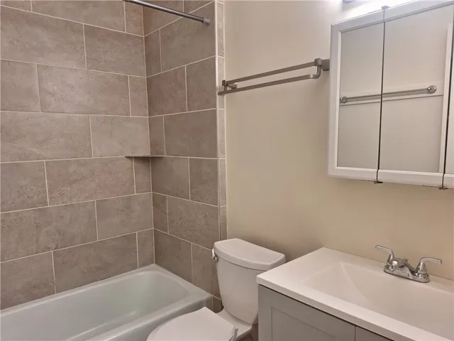 A classic tiled shower surround pairs with a modern vanity in this bathroom.