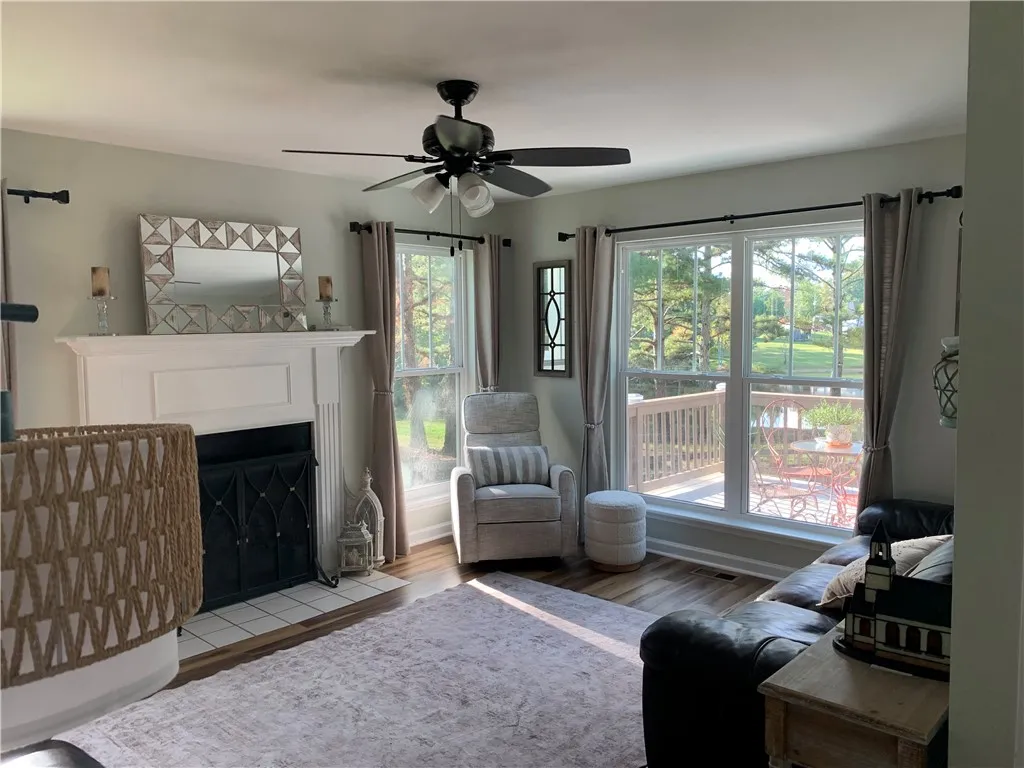 Large windows frame views of the rear deck and yard from this comfortable living space.