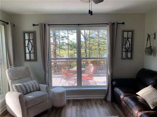 Expansive windows frame peaceful views of the water and surrounding greenery.