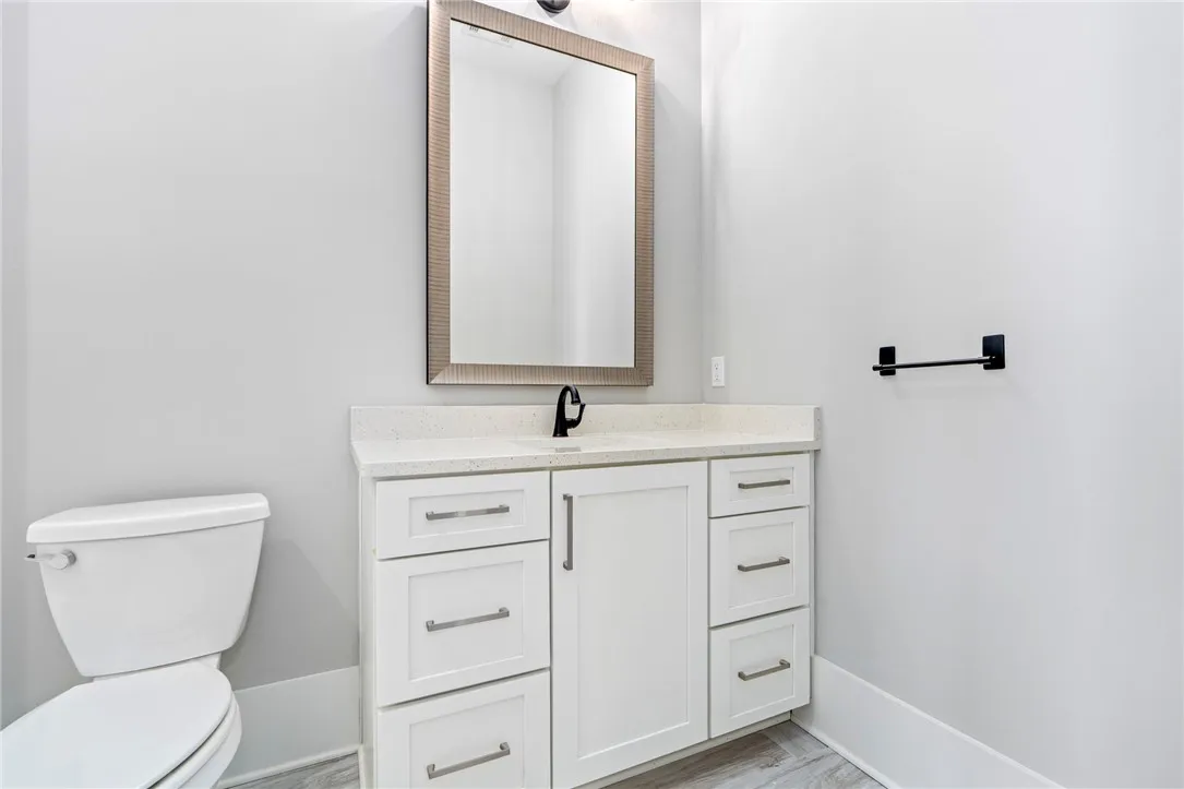 Smooth walls and a modern vanity define this pristine half bath.
