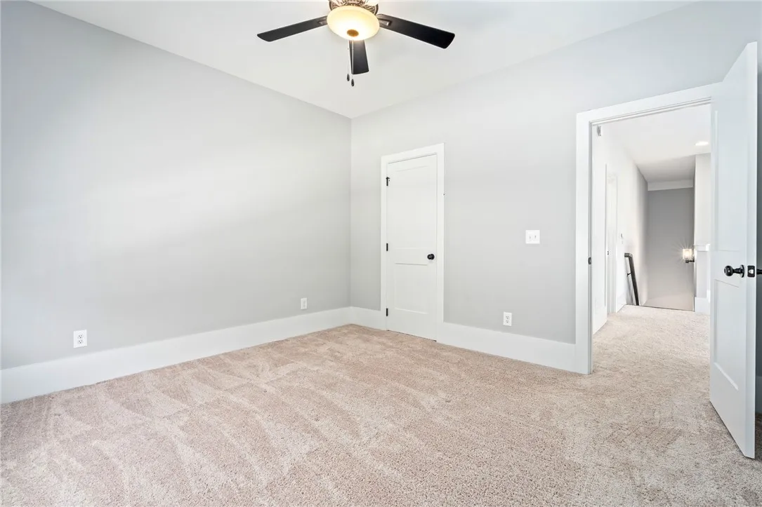 Plush carpeting and clean baseboards define this versatile secondary bedroom space.