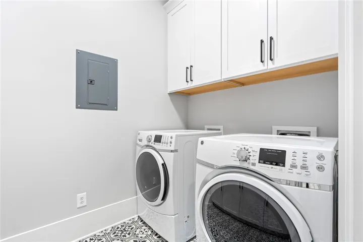 Custom cabinetry and patterned tile flooring elevate this highly functional laundry room.