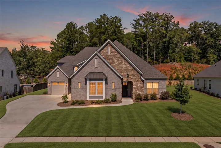 Striking brick and stone architecture pairs beautifully with manicured landscaping.