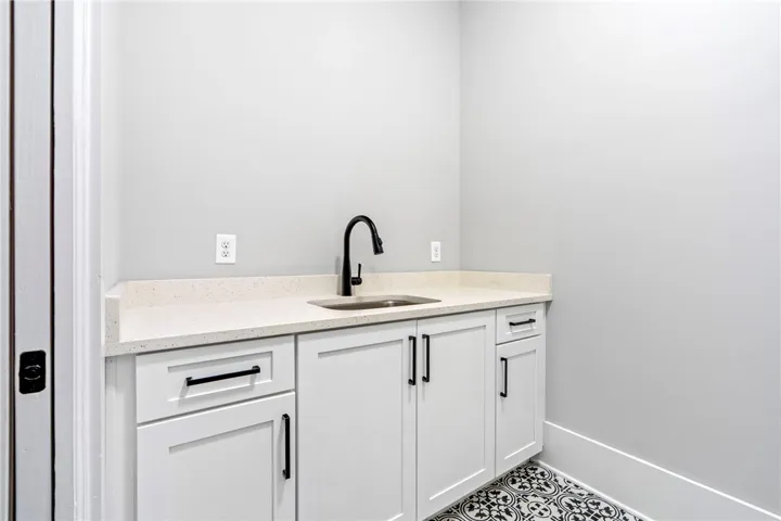 laundry room with a sink and folding countertop