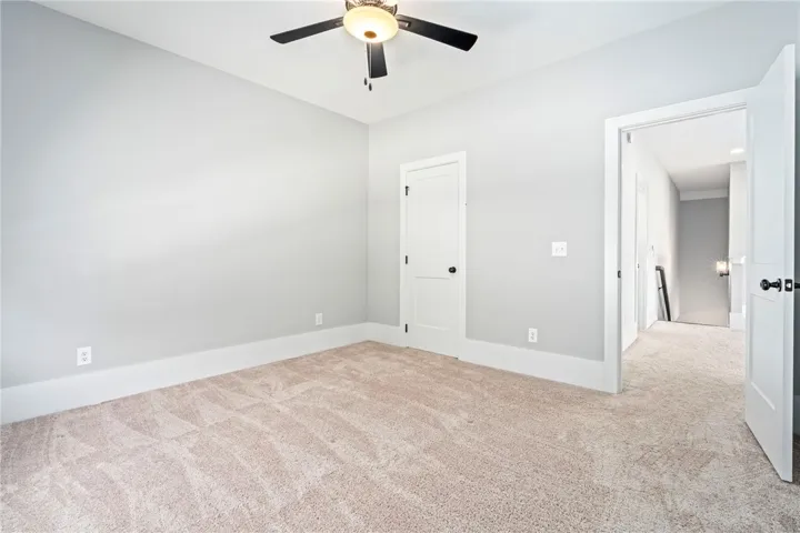Plush carpeting and clean baseboards define this versatile secondary bedroom space.