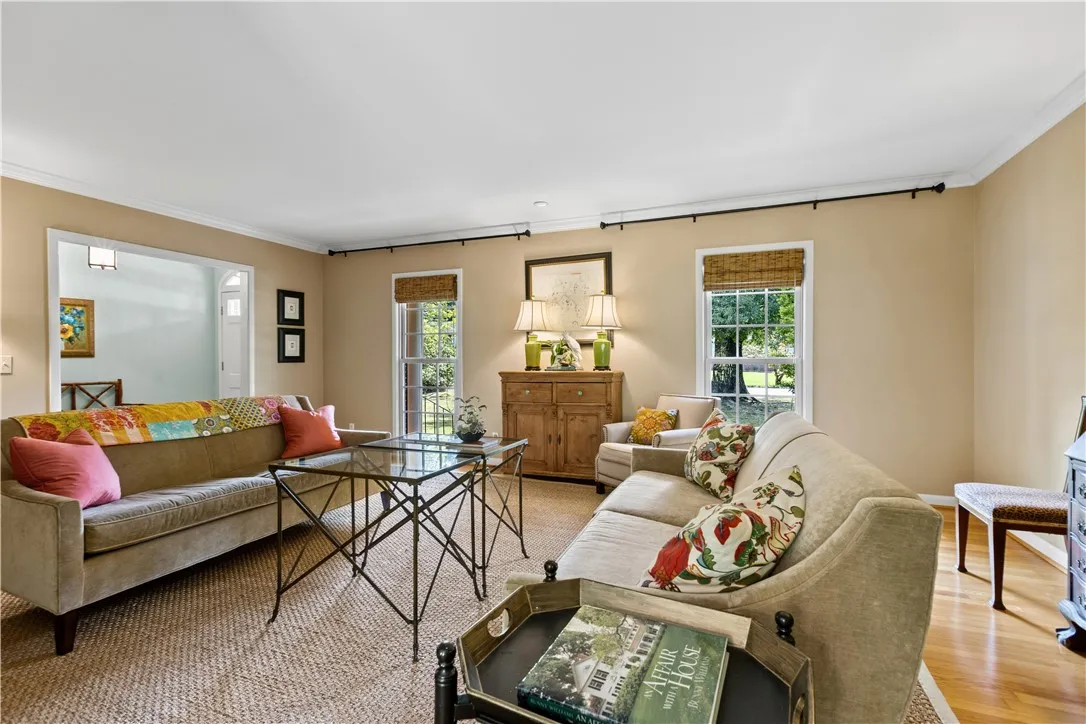 Hardwood floors and classic crown molding elevate this welcoming living space.