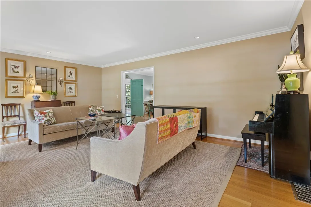 Gleaming hardwood floors and classic crown molding anchor this welcoming living area.