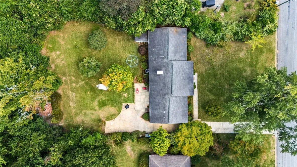 Mature trees surround this home, which sits on a generous green 0.49-acre lot.