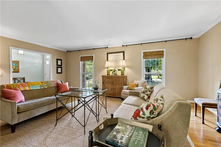 Hardwood floors and classic crown molding elevate this welcoming living space.