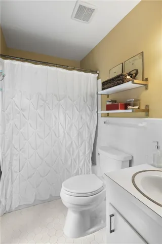 Crisp white wall tile and a clean vanity define this functional primary bath.