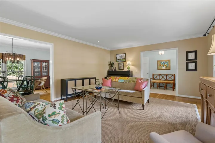 Elegant crown molding complements warm wood floors in an inviting, open layout.
