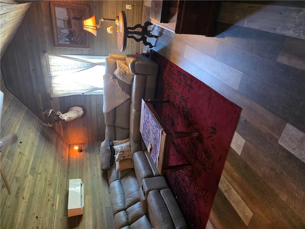 Warm wood-paneled walls and matching plank flooring create an inviting rustic cabin atmosphere.