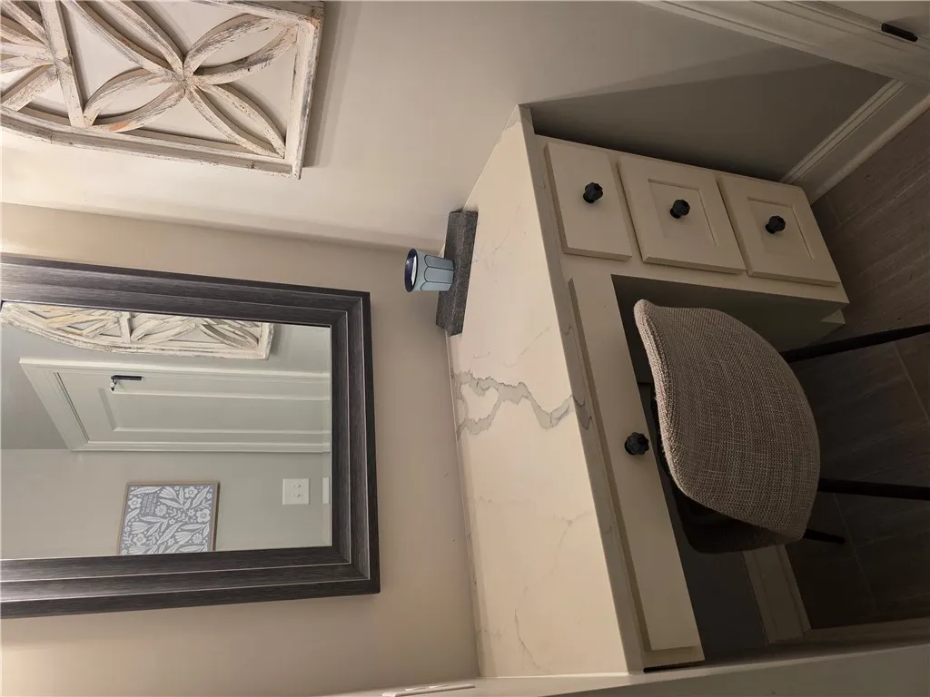 A built-in desk alcove incorporates stone counters and sleek integrated cabinetry.