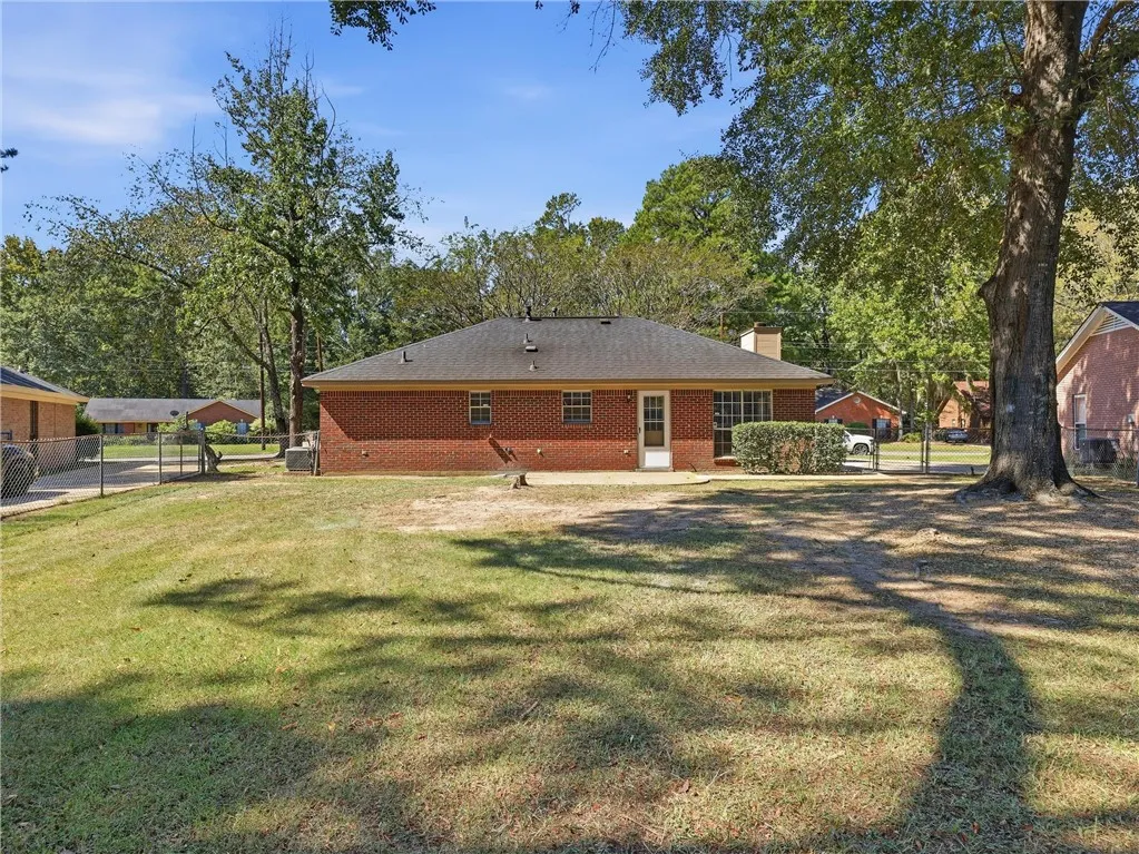 Mature trees shade a spacious grassy backyard behind this classic brick​​‌​​​​‌​​‌‌​‌‌​​​‌‌​‌​‌​‌​​​‌​​ home.