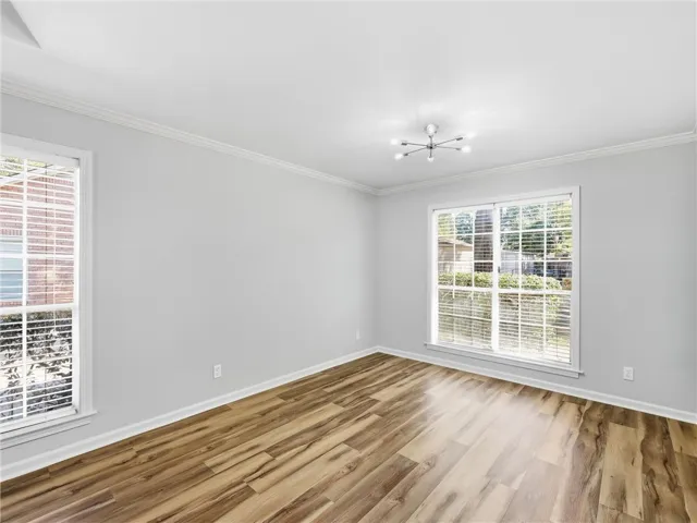 Gleaming hardwood floors and classic crown molding define this versatile living space.