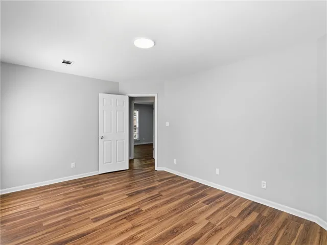 Gleaming hardwood floors and clean white walls define this versatile interior space.