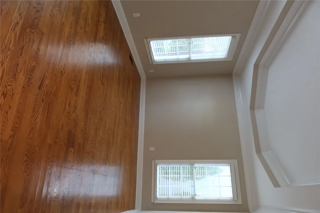 Gleaming hardwood floors and a tray ceiling define this elegant, light-filled space.