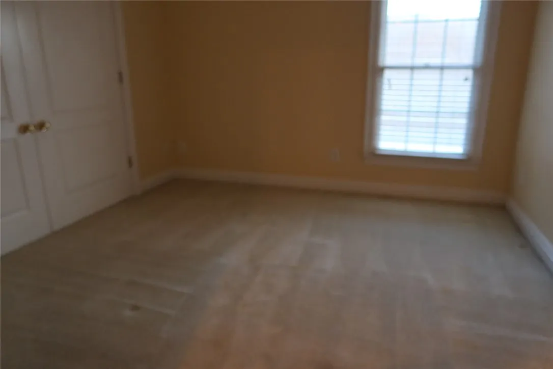 Plush carpeting and classic molding define this quiet, light-filled bedroom retreat.