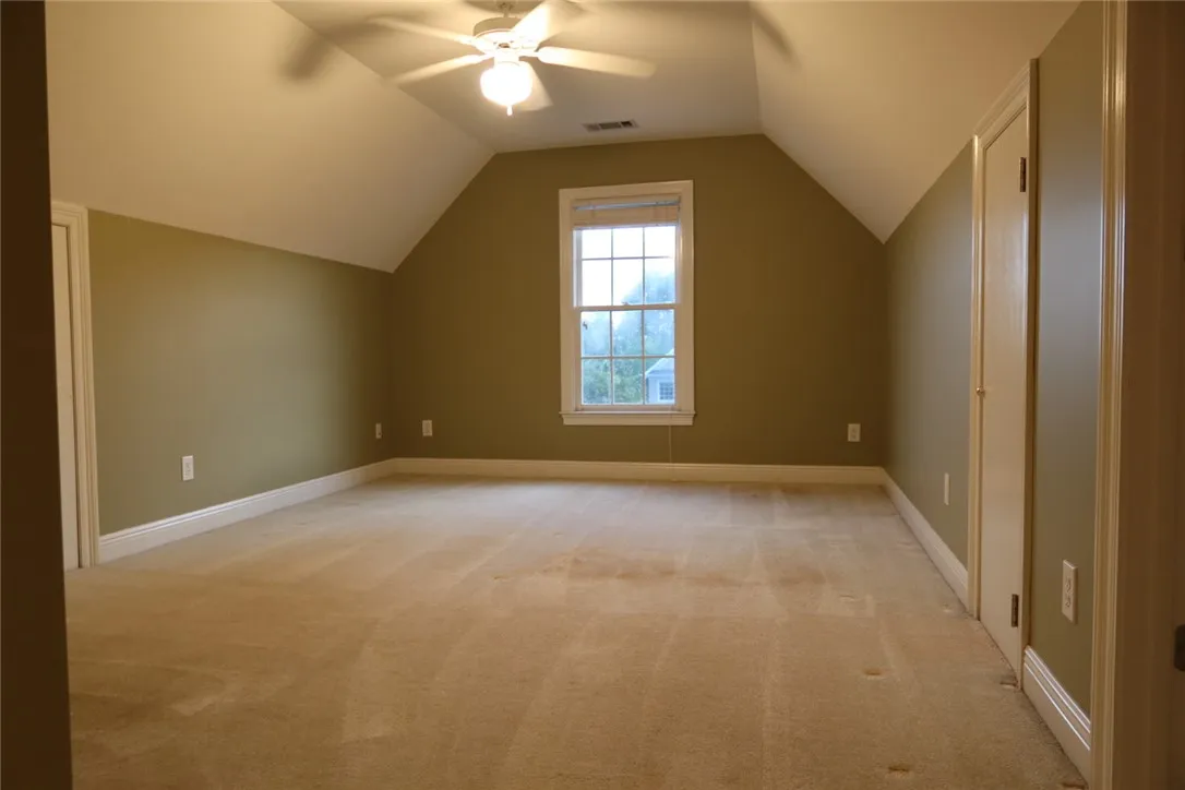 Angled ceilings and soft carpet define this versatile upper-level space.