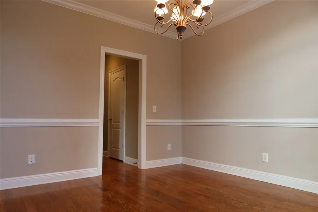 Gleaming hardwood floors and classic crown molding define this elegant interior space.