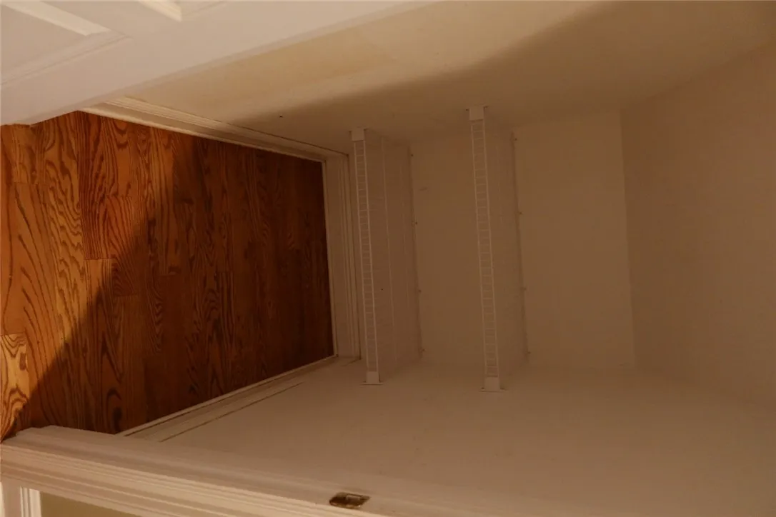 Gleaming hardwood floors run throughout this functional closet space featuring built-in wire shelving.