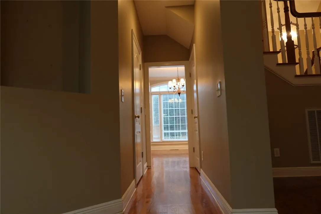 Gleaming hardwood floors guide the way through this centrally located interior hallway.