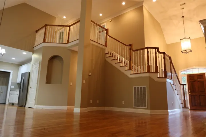 Gleaming hardwood floors and a soaring staircase create a memorable first impression.