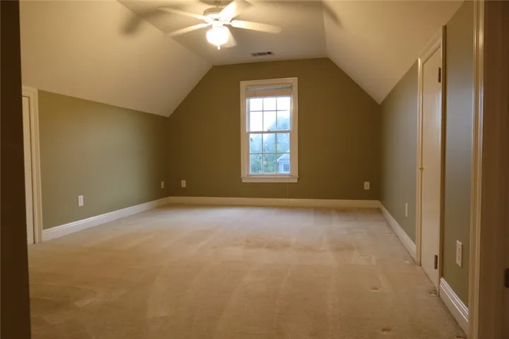 Angled ceilings and soft carpet define this versatile upper-level space.