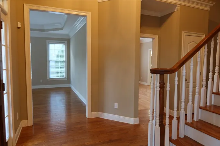Polished hardwood floors and elegant crown molding define this welcoming entryway.