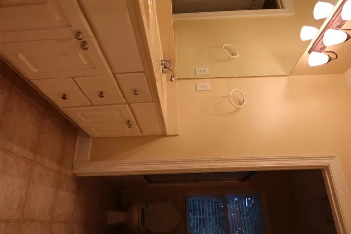 Double vanity sinks and ceramic tile flooring define this functional bathroom layout.
