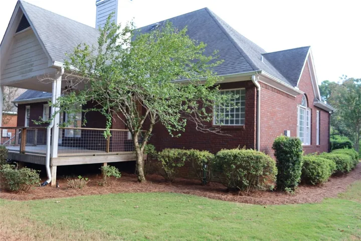 Classic brick architecture defines this exterior complete with a spacious elevated wood deck.