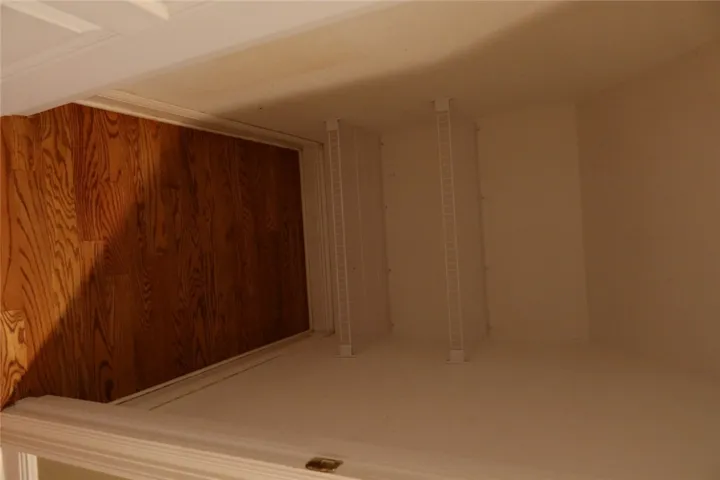 Gleaming hardwood floors run throughout this functional closet space featuring built-in wire shelving.
