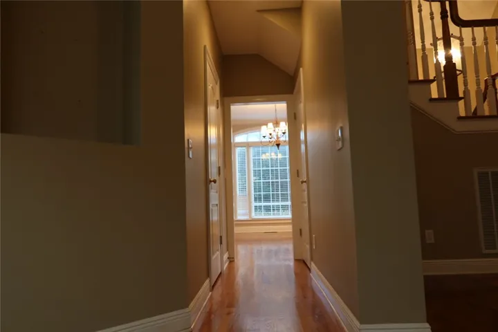 Gleaming hardwood floors guide the way through this centrally located interior hallway.